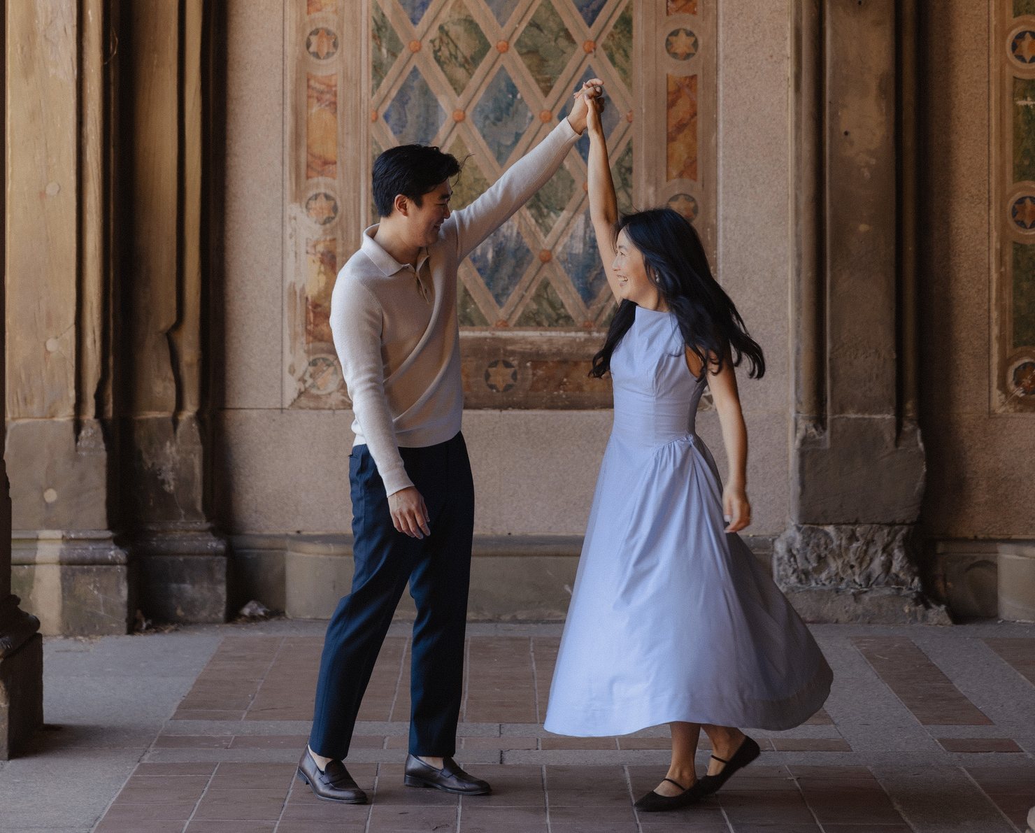 Grace and David dancing a twirl under the painted arches of Bethesda Terrace, Central Park
